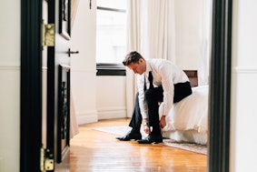 Guy getting dressed in suit