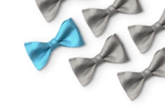 Gray bow ties with one blue bow tie laying in a grid.