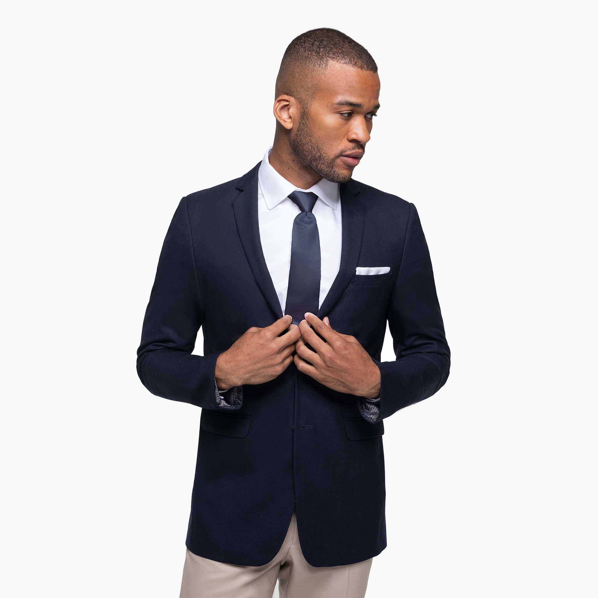 Navy blue jacket with light grey trousers